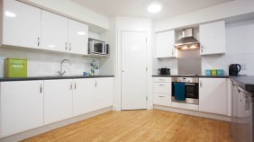 Ropemaker Court Kitchen with fridge, freezer, washing machine, oven, cupboards, sink and microwave