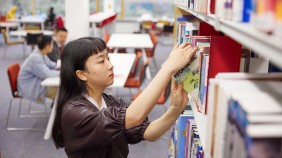 Student browsing books in a library
