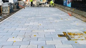 Granite paving laid along the wall of All Saints park